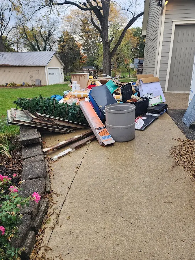 Dumpster being loaded with debris for Roofing Dumpster Rental in Holly Ridge